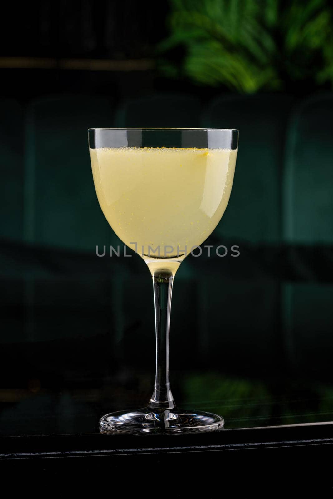 Iced yellow lemon and citrus cocktail with lemon zest
