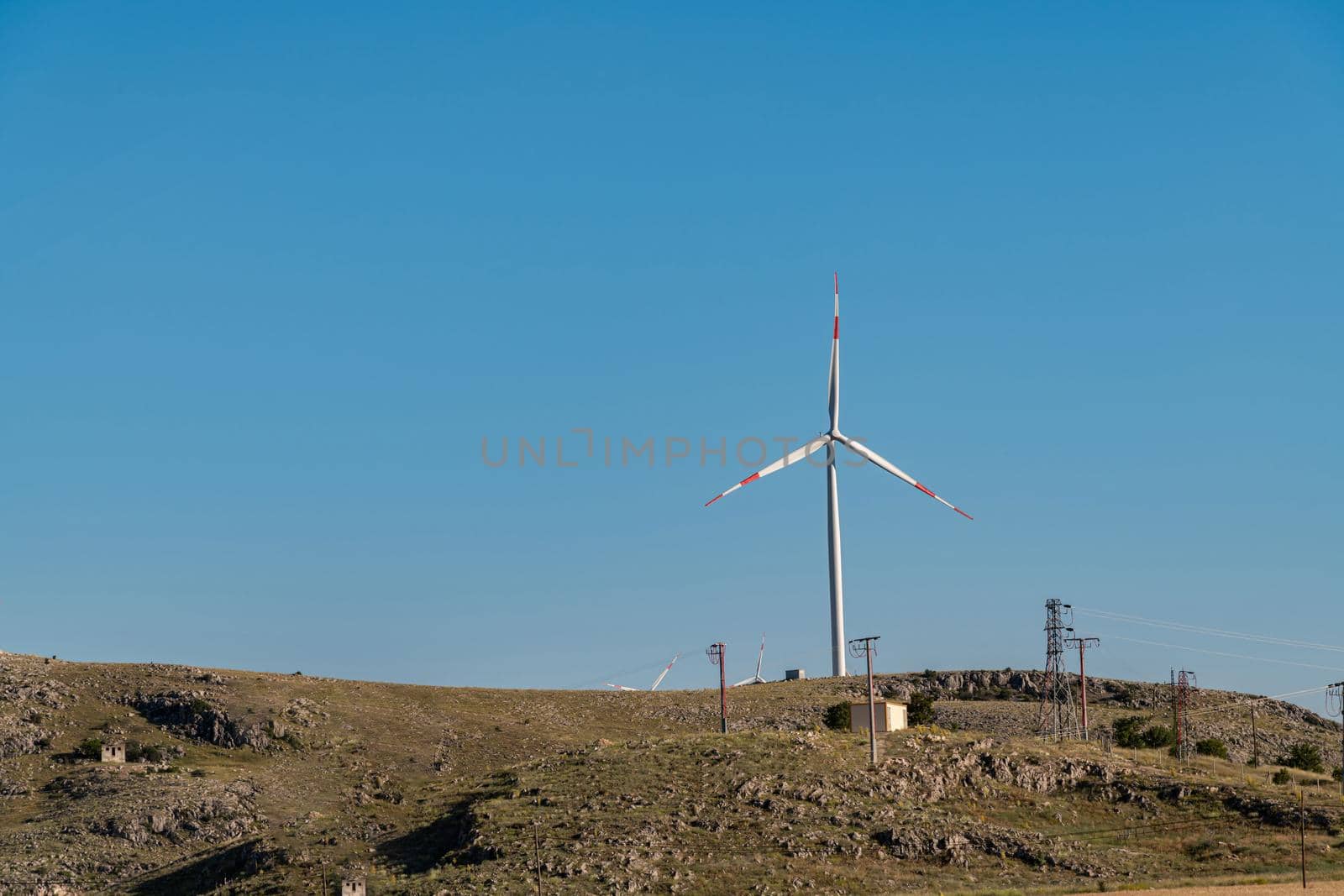 clean electricity producing wind turbine or windmill built on a windy mountain ridge by Sonat