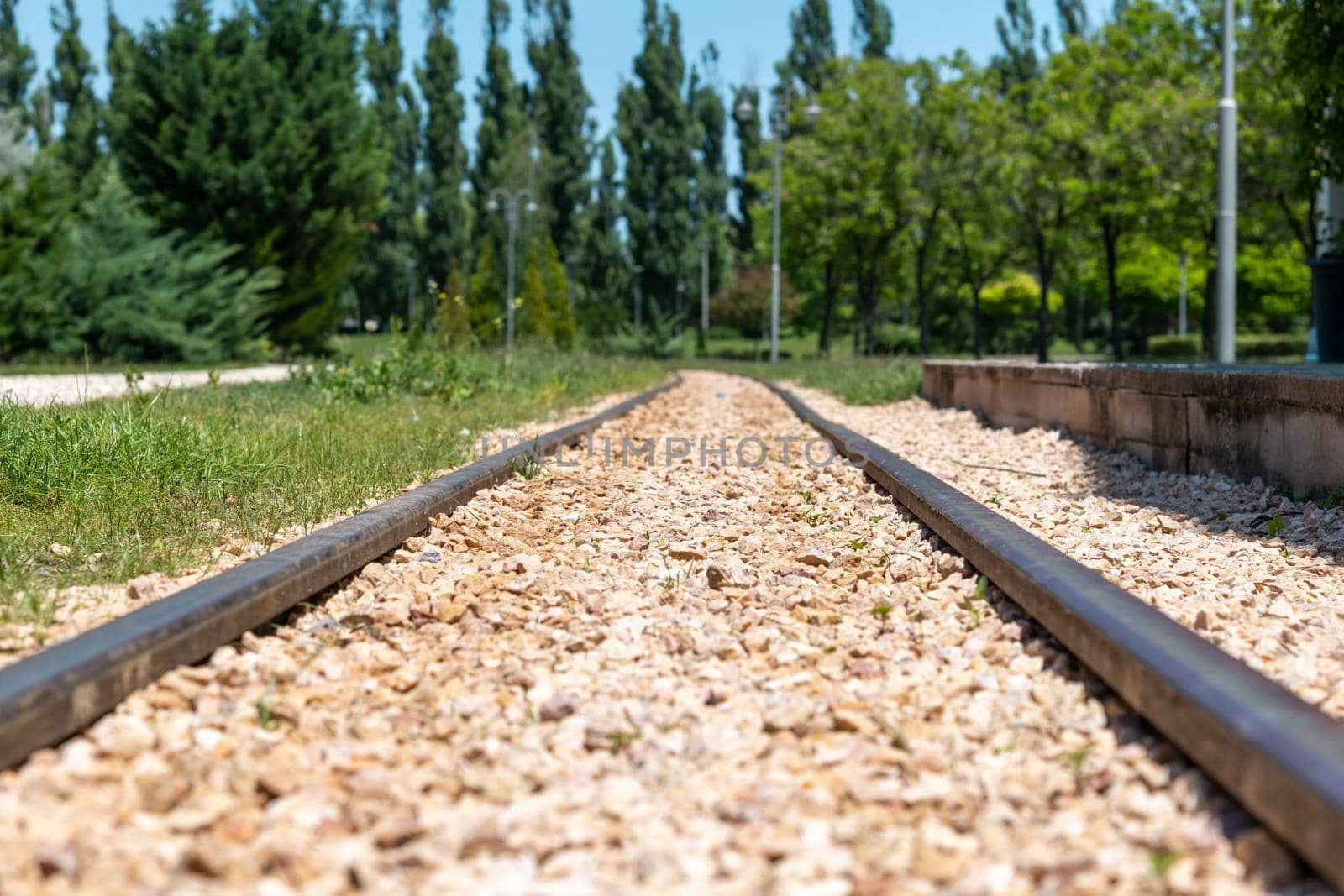 Railway tracks in front of the railway station on a sunny day at horizontal angle