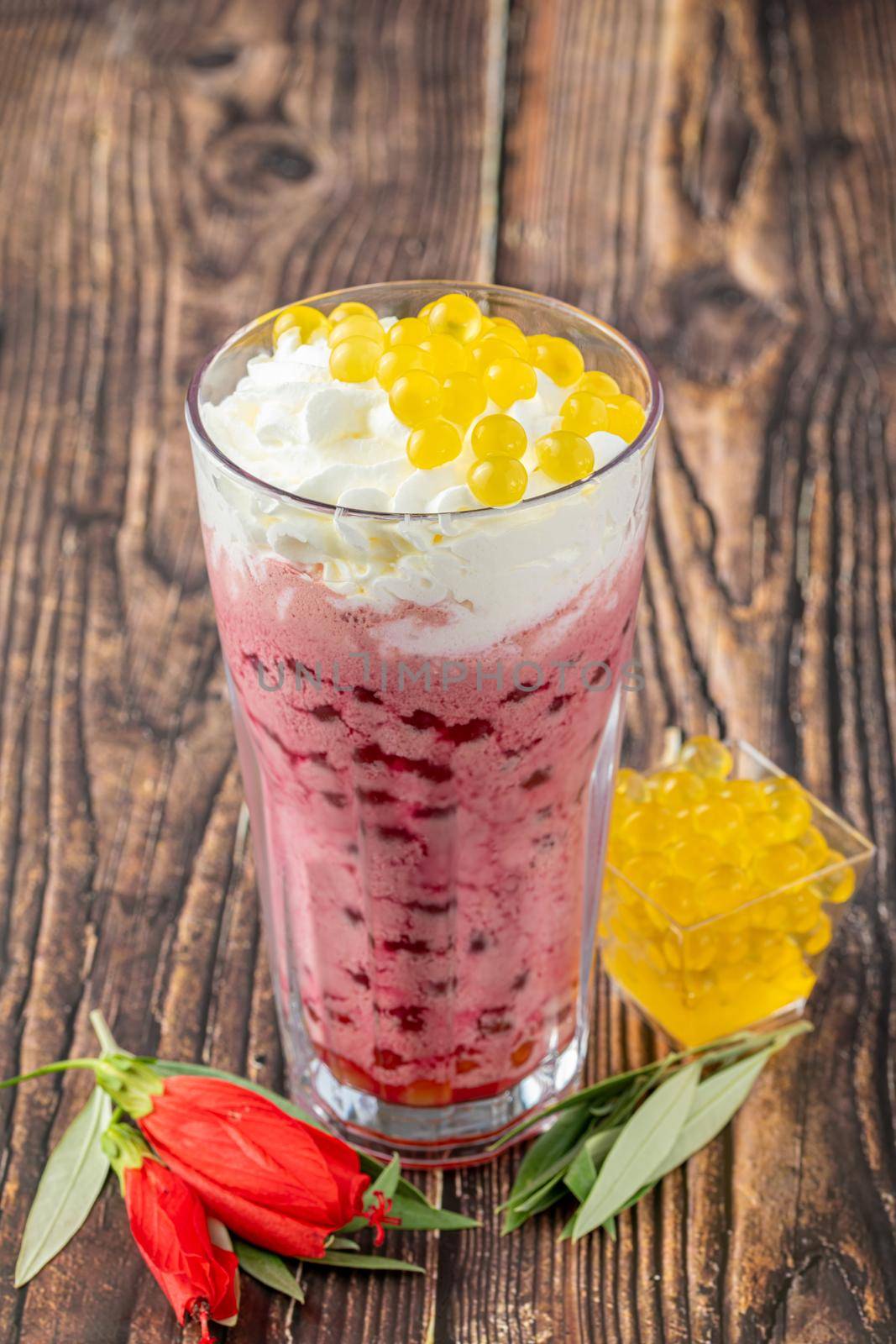 Strawberry, lemon and bubble tea milkshake or smoothie on wooden table by Sonat