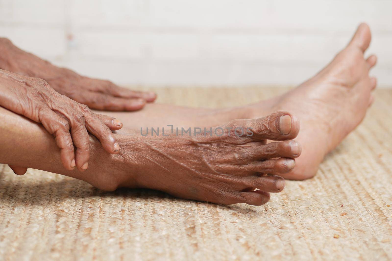 Close up on senior women feet and hand massage on injury spot