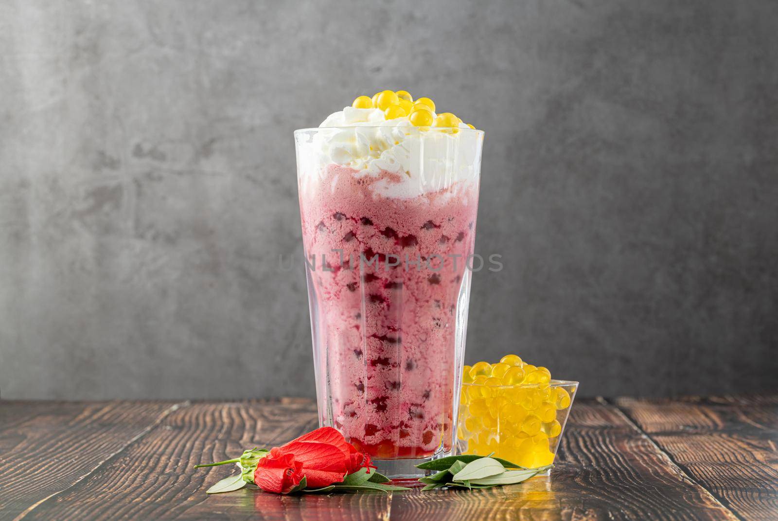 Strawberry, lemon and bubble tea milkshake or smoothie on wooden table by Sonat