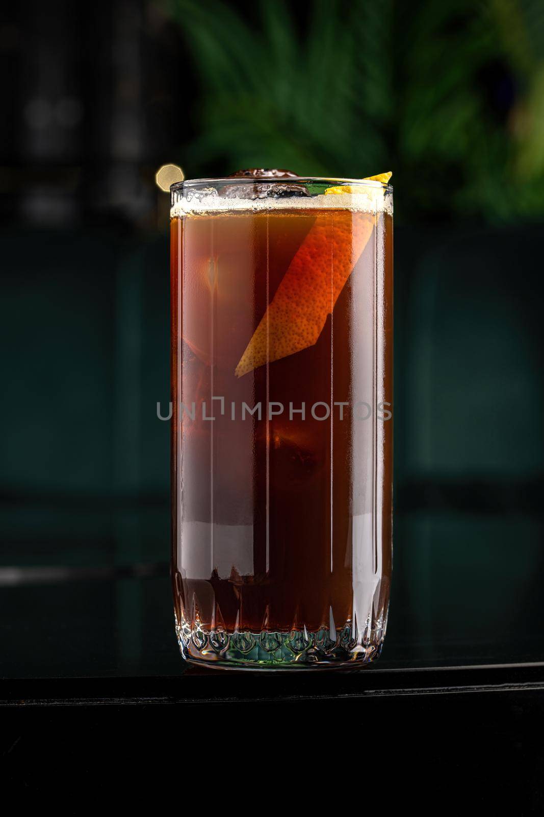 Refreshing citrus and alcoholic cocktail on dark background