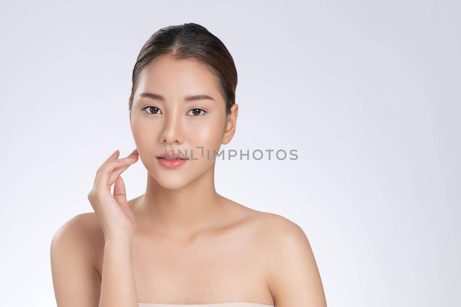 Portrait of gorgeous young girl posing beauty gesture with clean fresh skin. by biancoblue