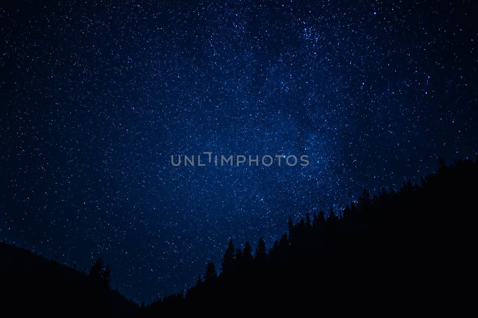 Night sky with stars, satellites. Milky Way passing in long exposure. Beautiful panorama view with rock, mountain. Nature, universe, galaxy, astronomy concept. High quality photo