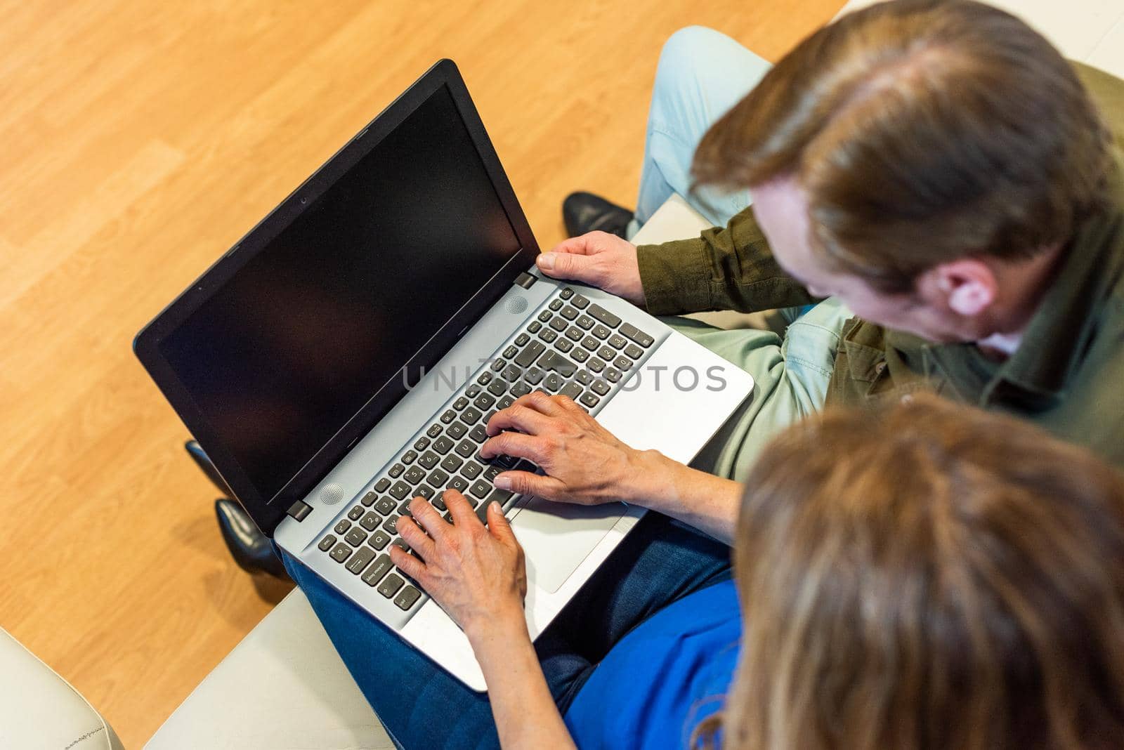 Mature man and woman in front of a laptop. Top view. by ivanmoreno