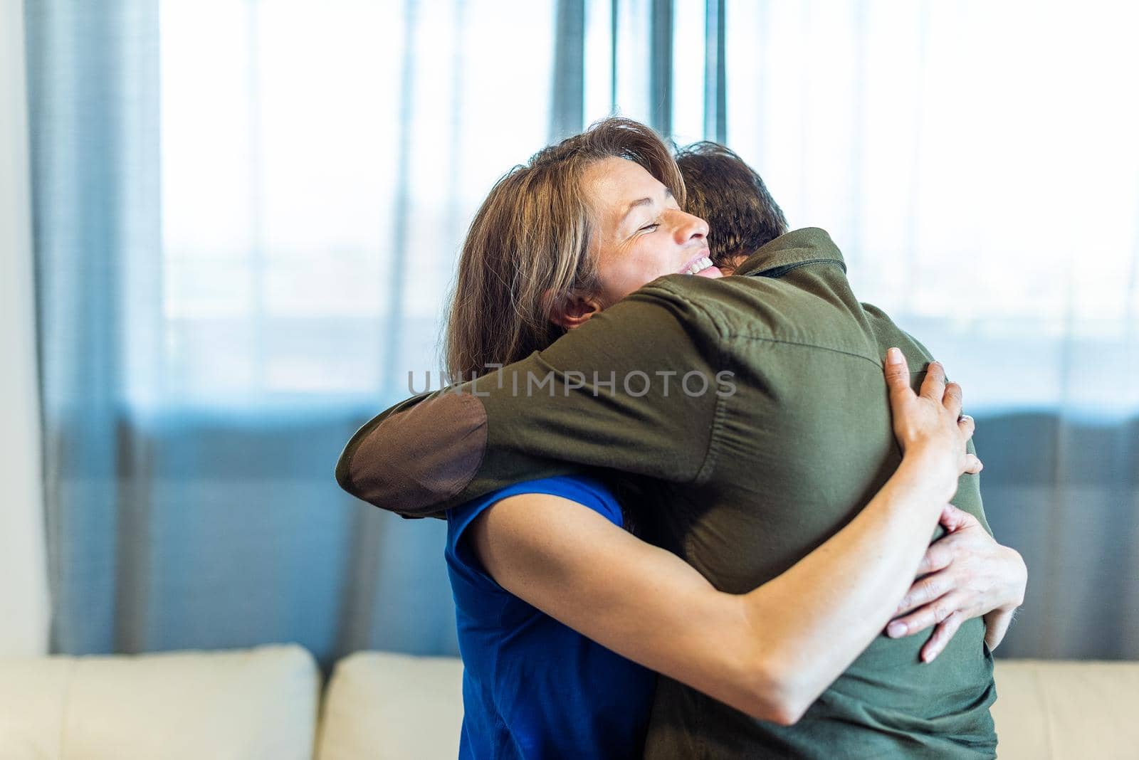 Mature man and woman hugging at home. High quality photo