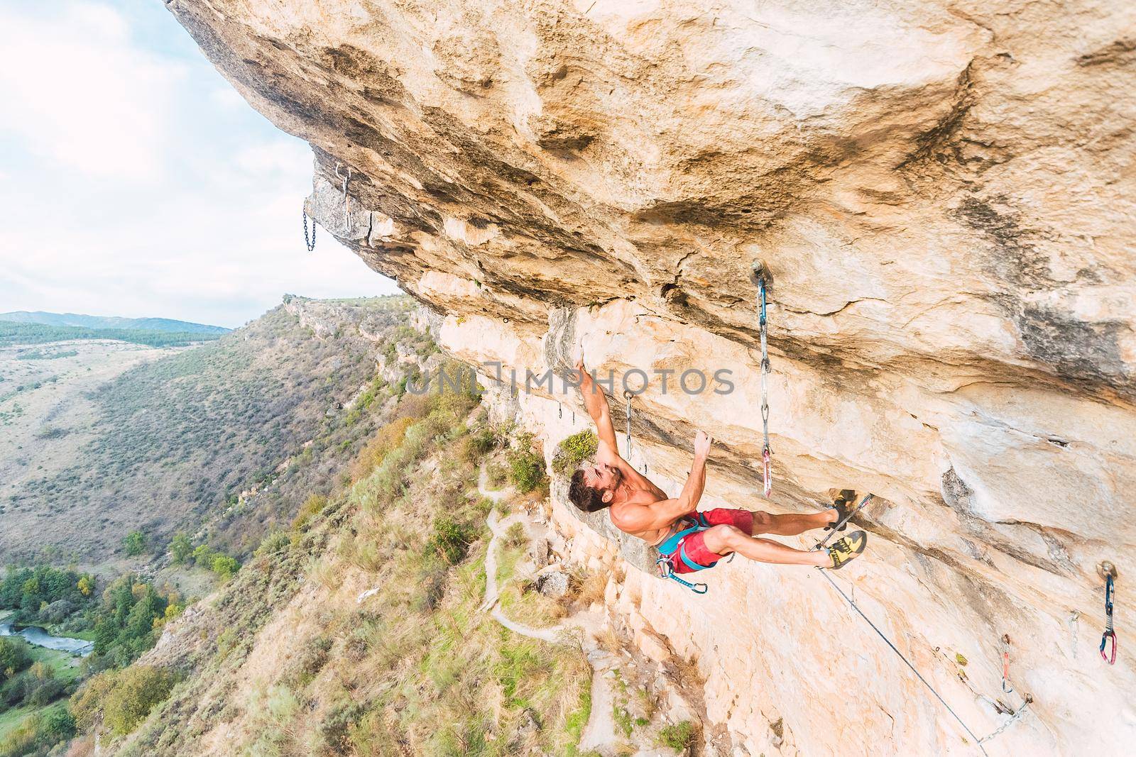 Aerial view of an adult man climbing a rock formation by ivanmoreno