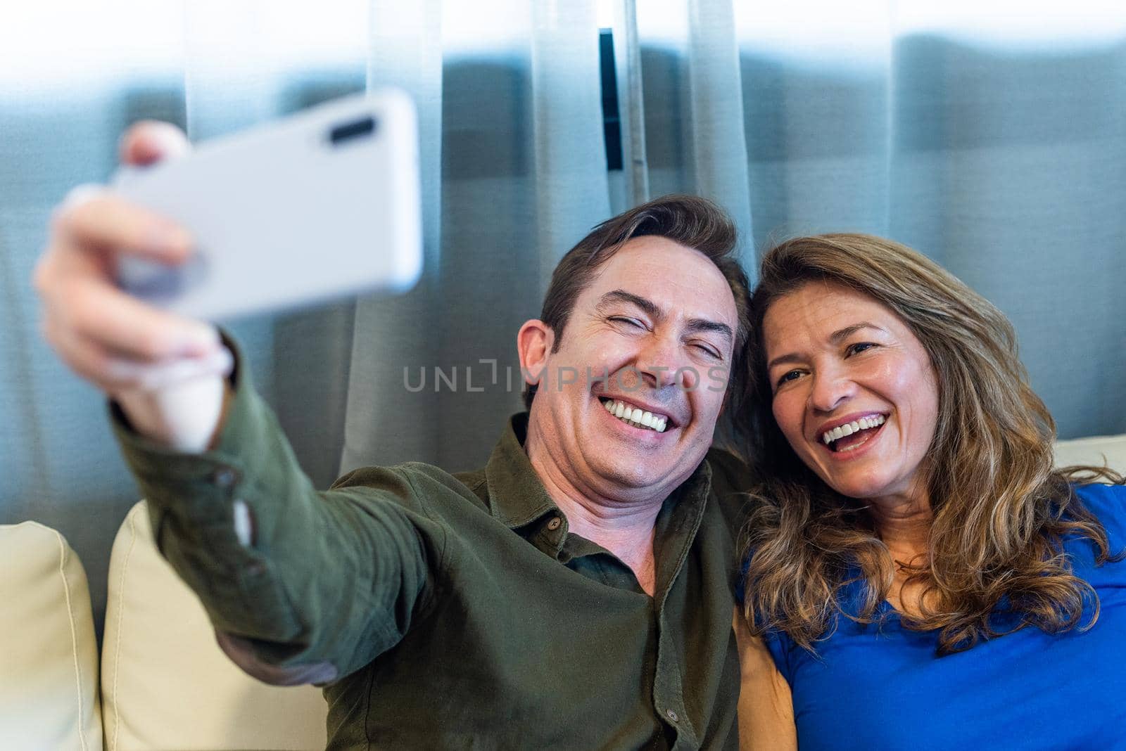 Smiling mature man and woman taking a selfie. High quality photo