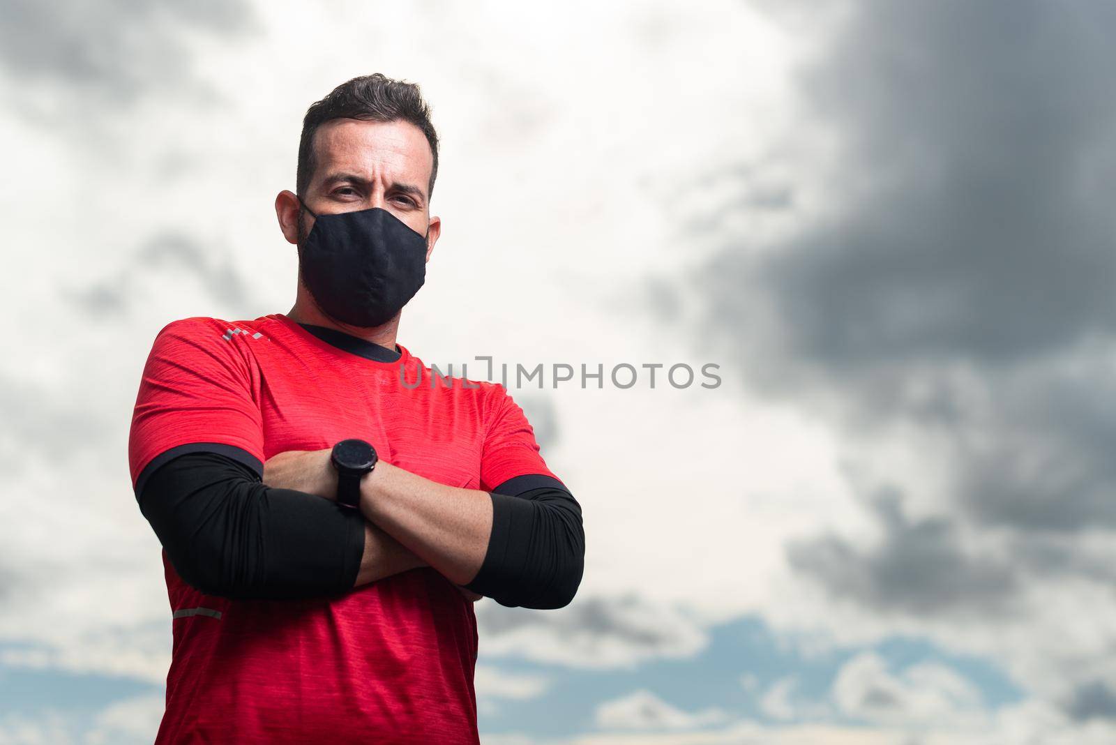 Sportsman with mask looking at camera seriously. by ivanmoreno