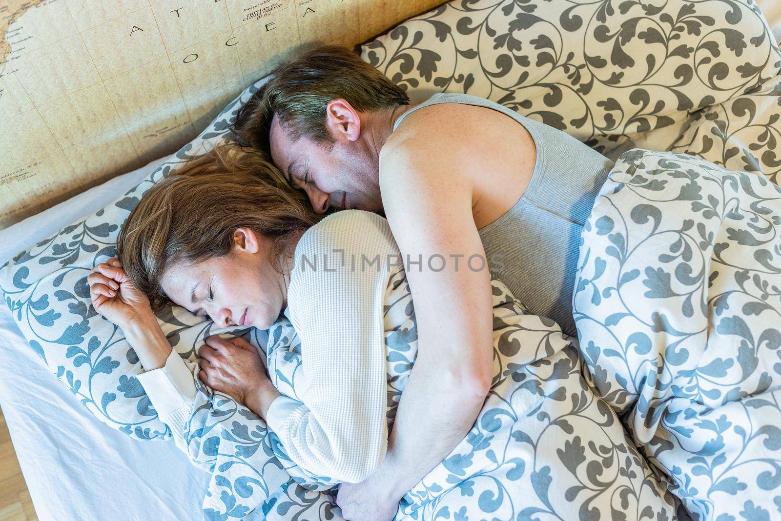 Mature couple sleeping in bed. Top view. High quality photo