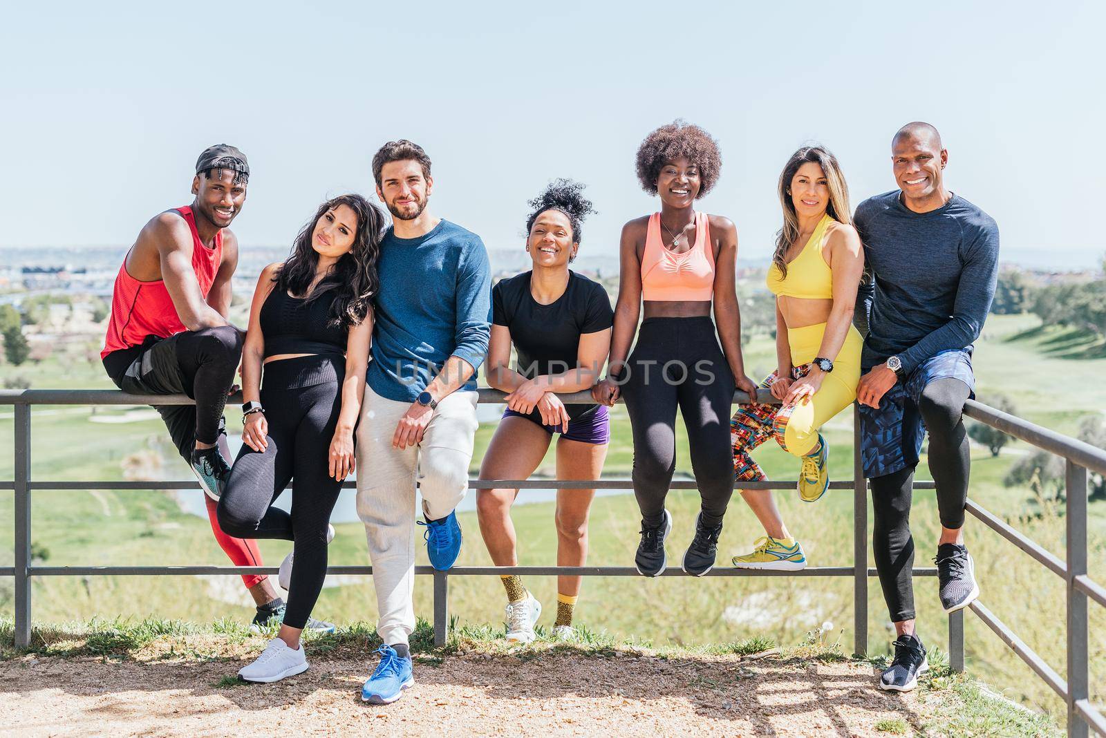 Group portrait of runners smiling at camera. Horizontal framing. by ivanmoreno