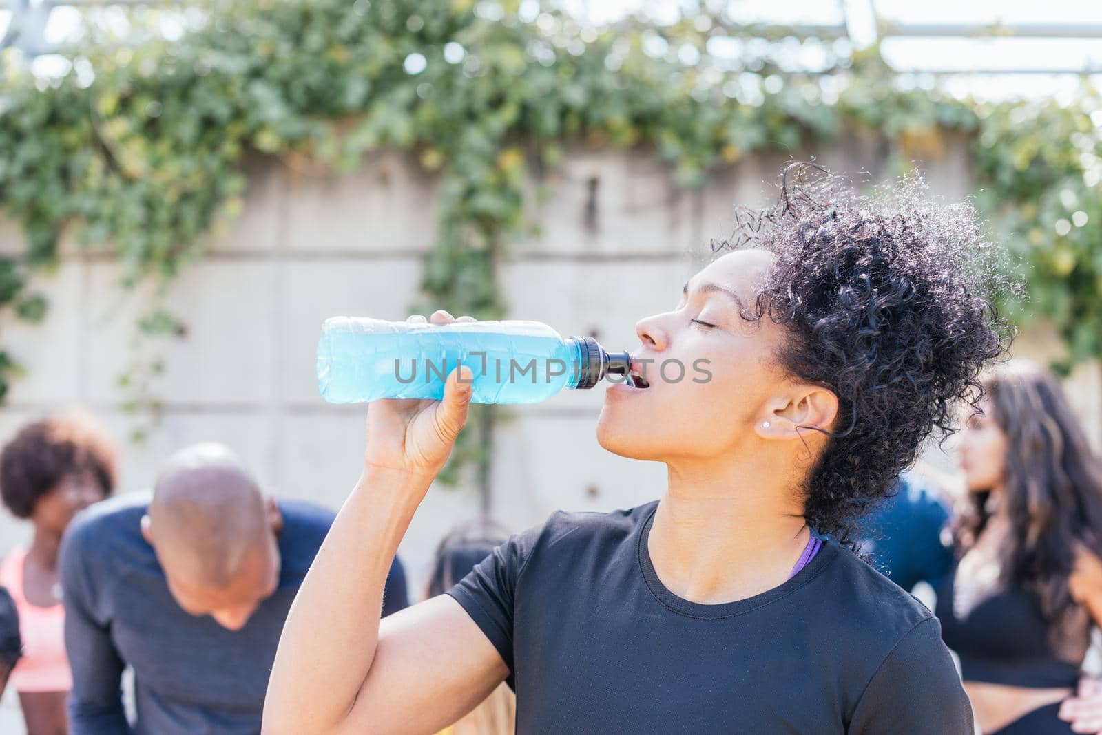 Runner woman drinking after a race. Horizontal framing.