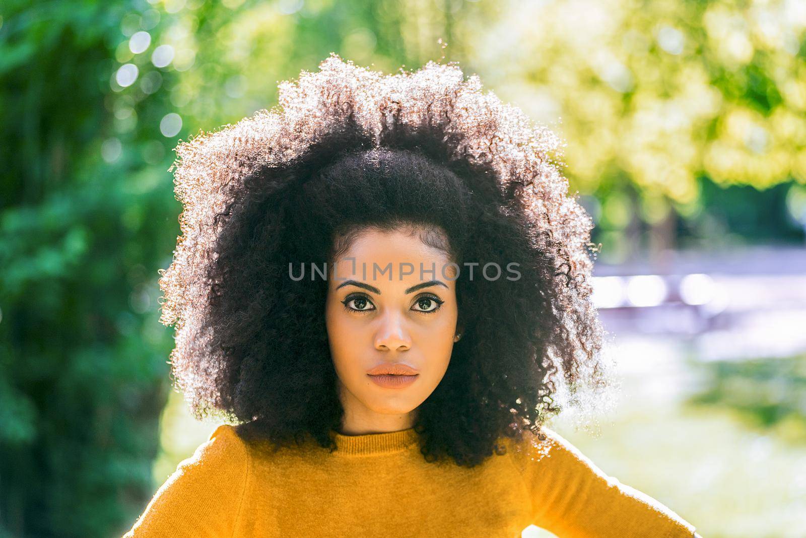 Portrait of nice afro girl in a garden. Close up. by ivanmoreno