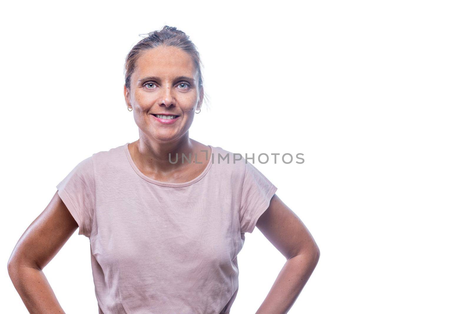 Front view of a green-eyed woman with her hands on her waist looking at camera on a white background with copy space.