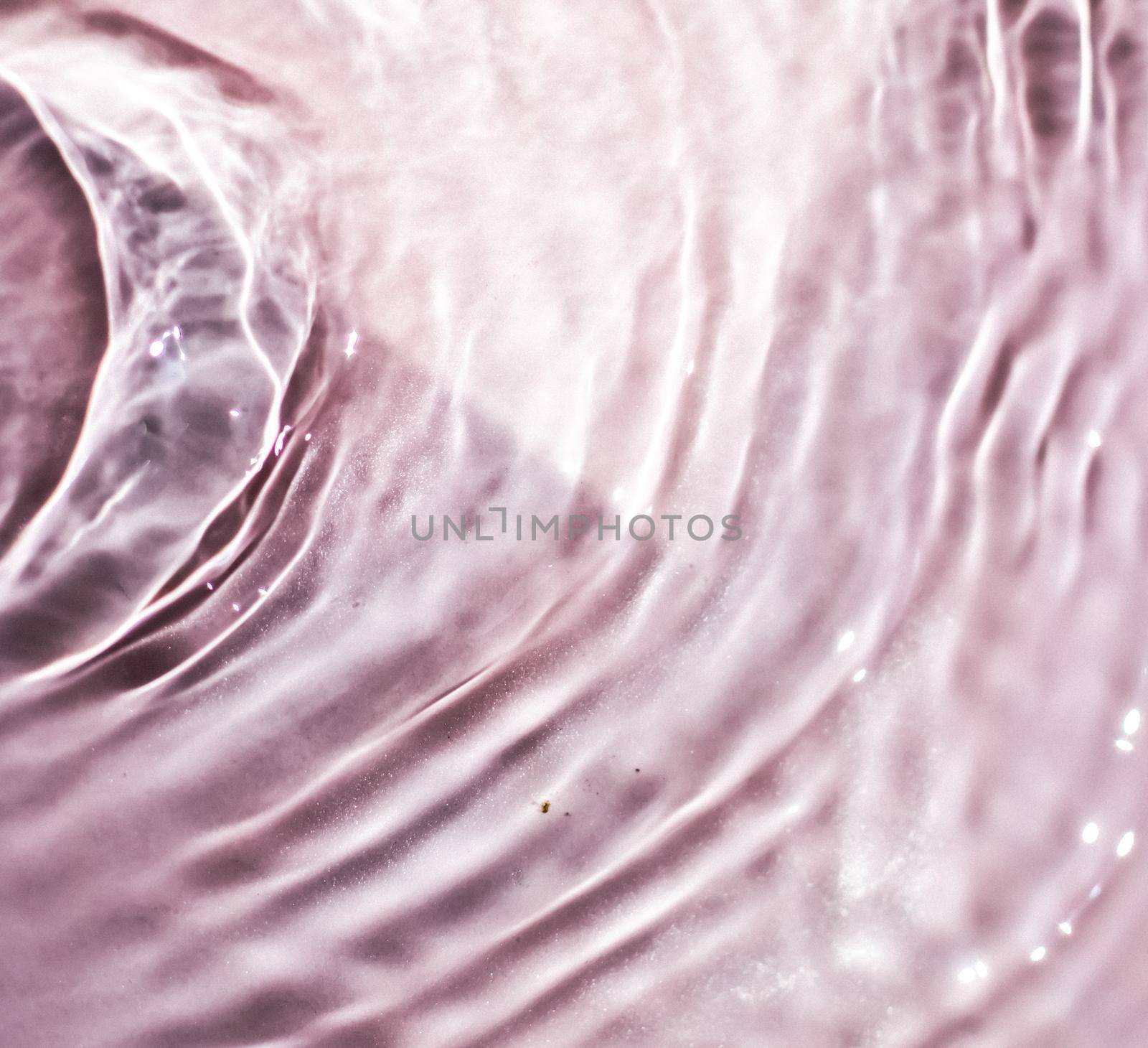 Pink flowing water texture as an abstract background - colourful liquids and creative designs concept. Pink flow