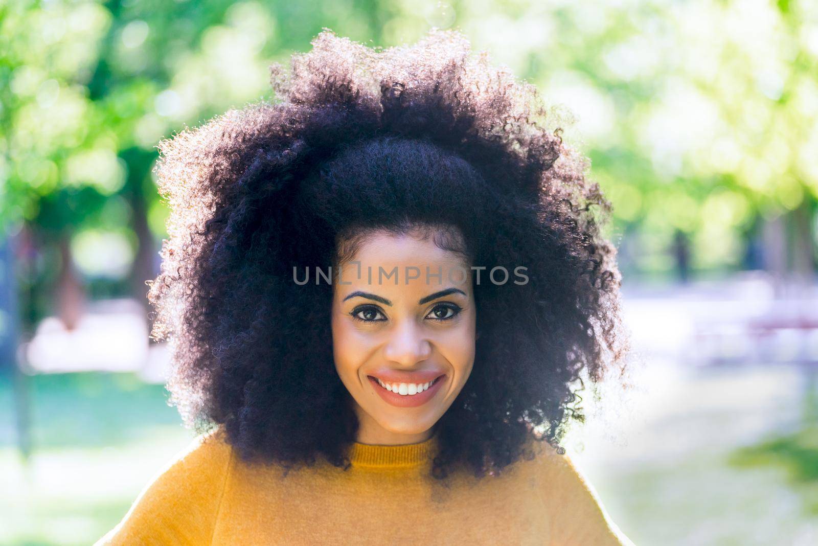 Portrait of nice and happy afro girl in a garden. Close up. by ivanmoreno