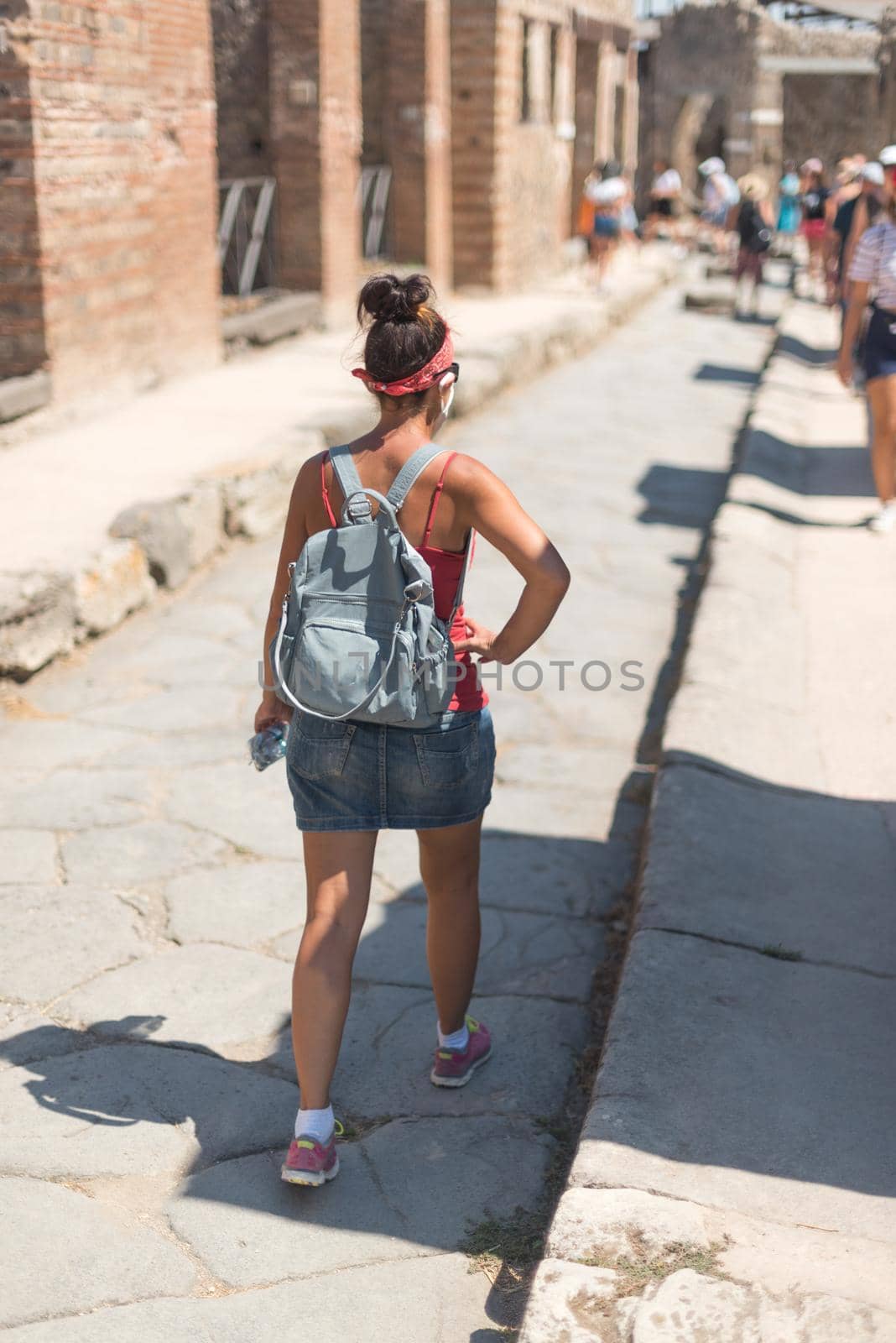 Woman walking through the Roman archaeological site of Pompeii, in Italy.