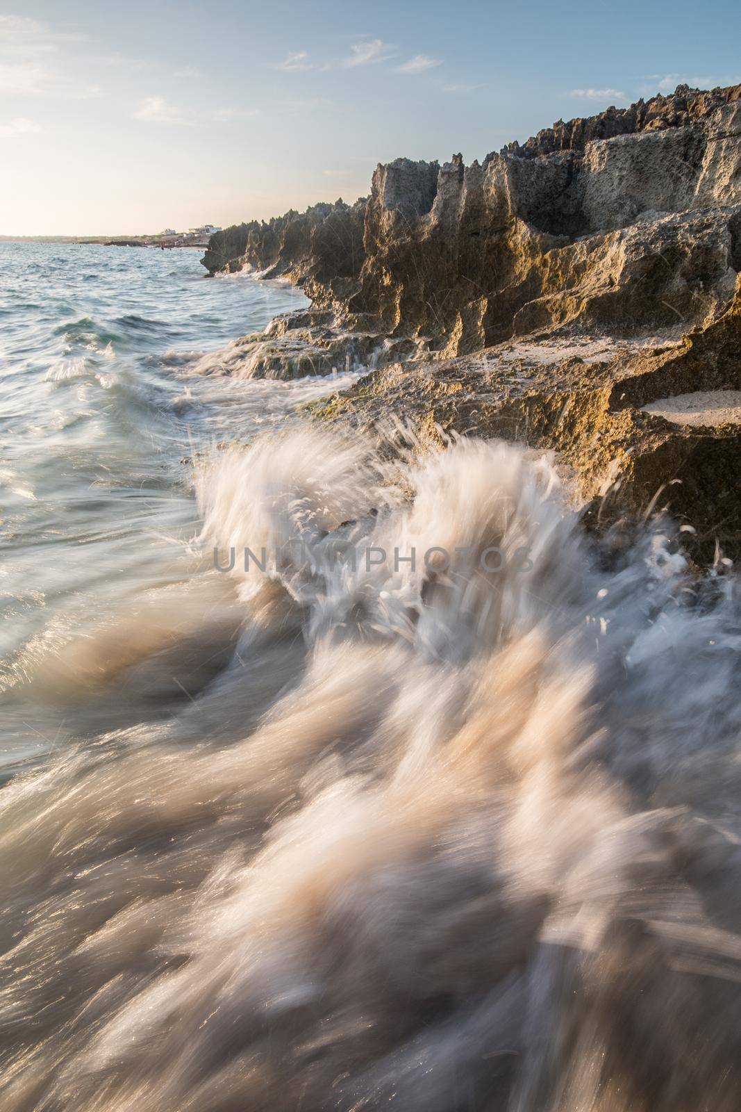 Seascape. Rough sea day with the waves crashing violently against the rocks on the shore. Formentera island, Spain.