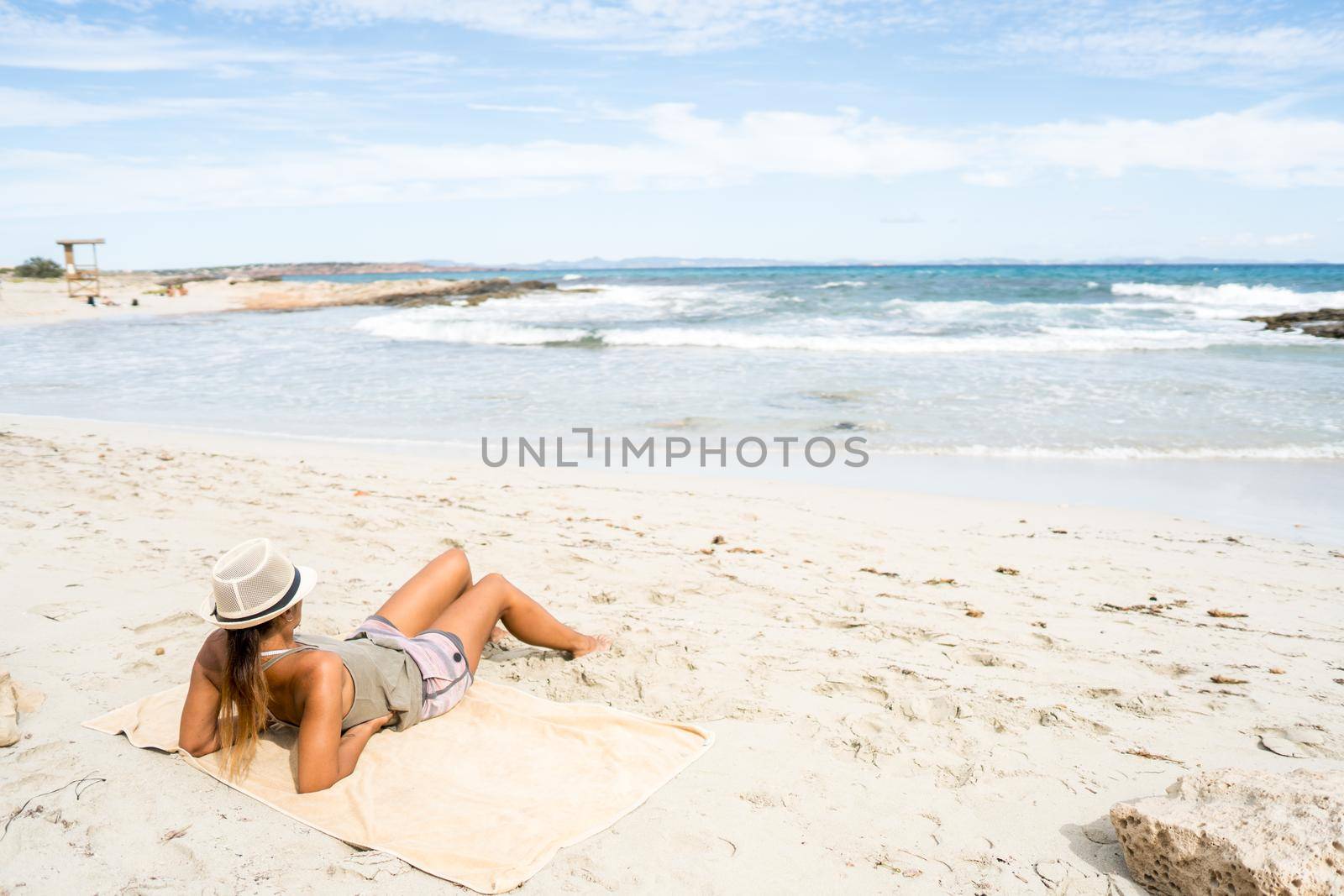 Pretty woman sunbathing on the beach.Formentera island, Spain. by ivanmoreno