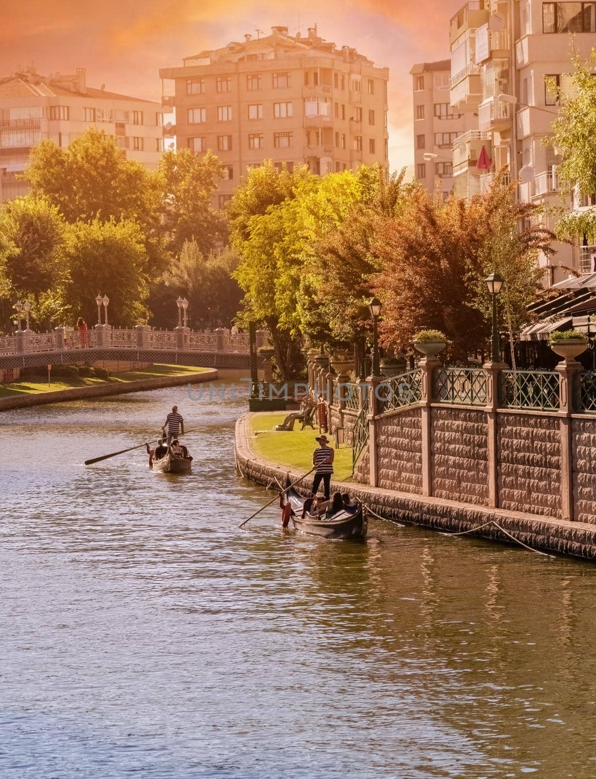 Antalya, Turkey - July 5, 2022: Touristic boat and gondola on the Porsuk River passing through the city center of Eskisehir