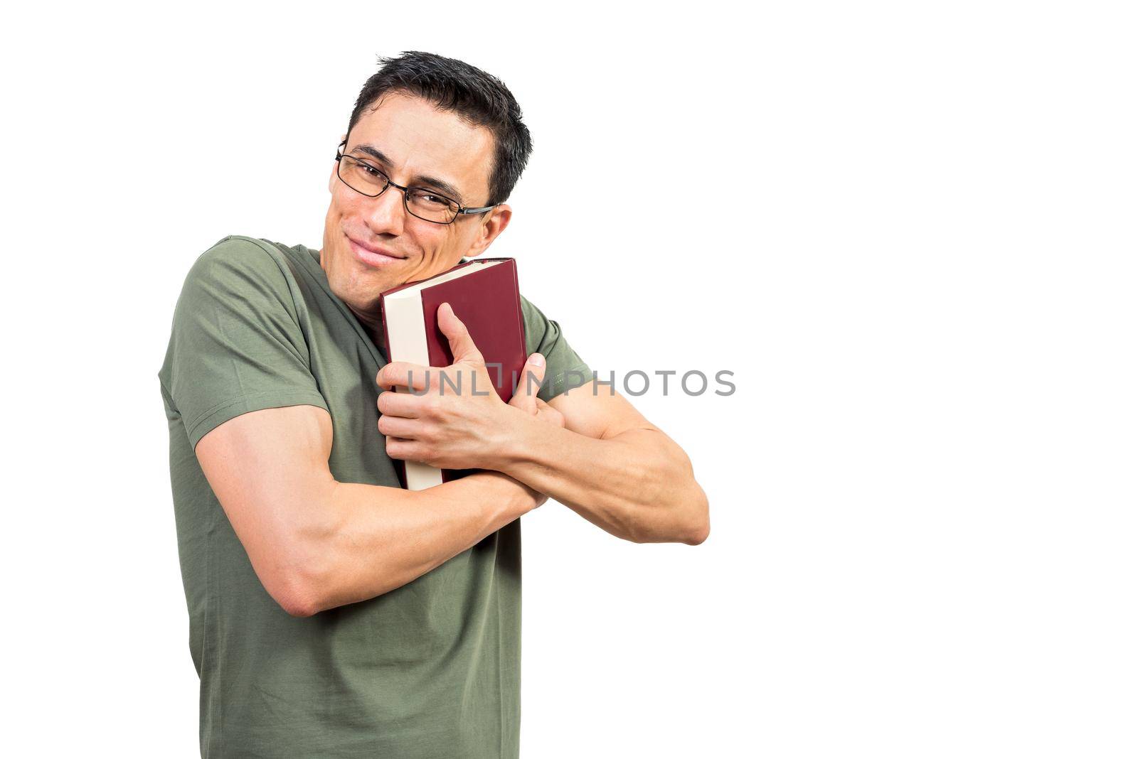 Happy smart man in green t shirt and glasses embracing interesting book and looking at camera against white background