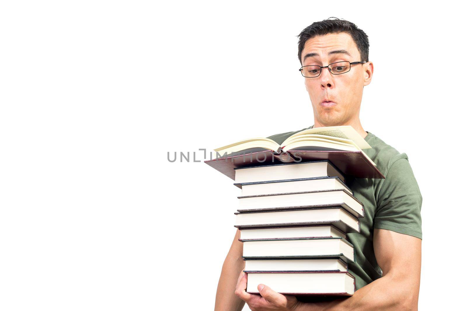 Inquisitive smart man in glasses carrying and reading fascinating data in books while studying against white background