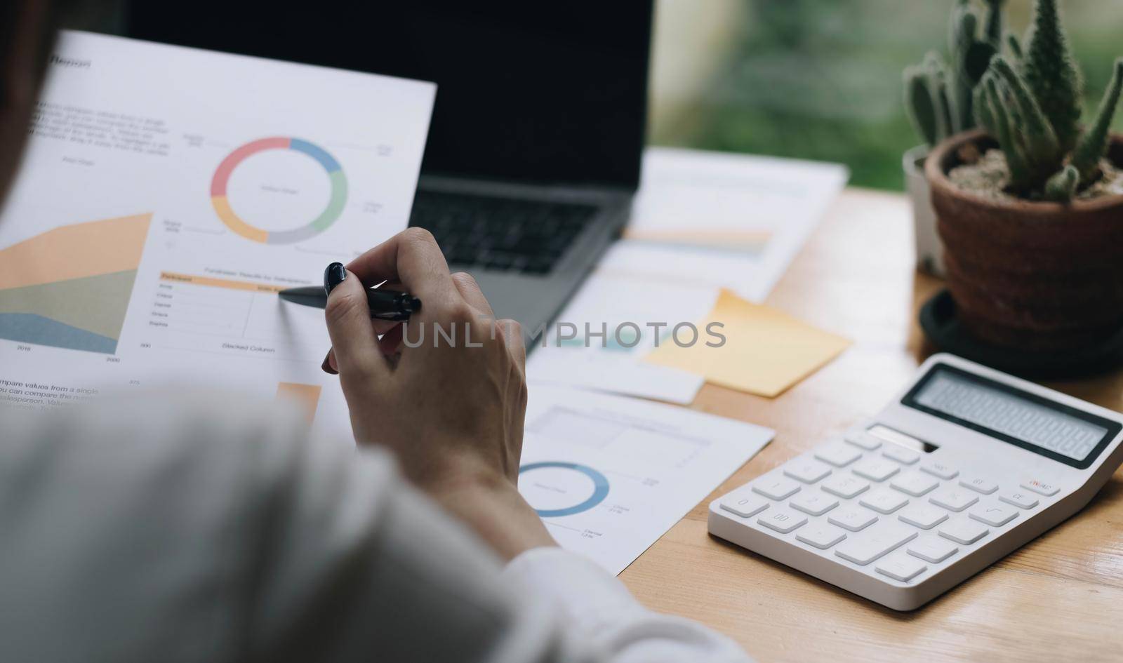 Asian accountant woman working audit budget and finance of company on wooden desk in office. consult, business, tax concept..