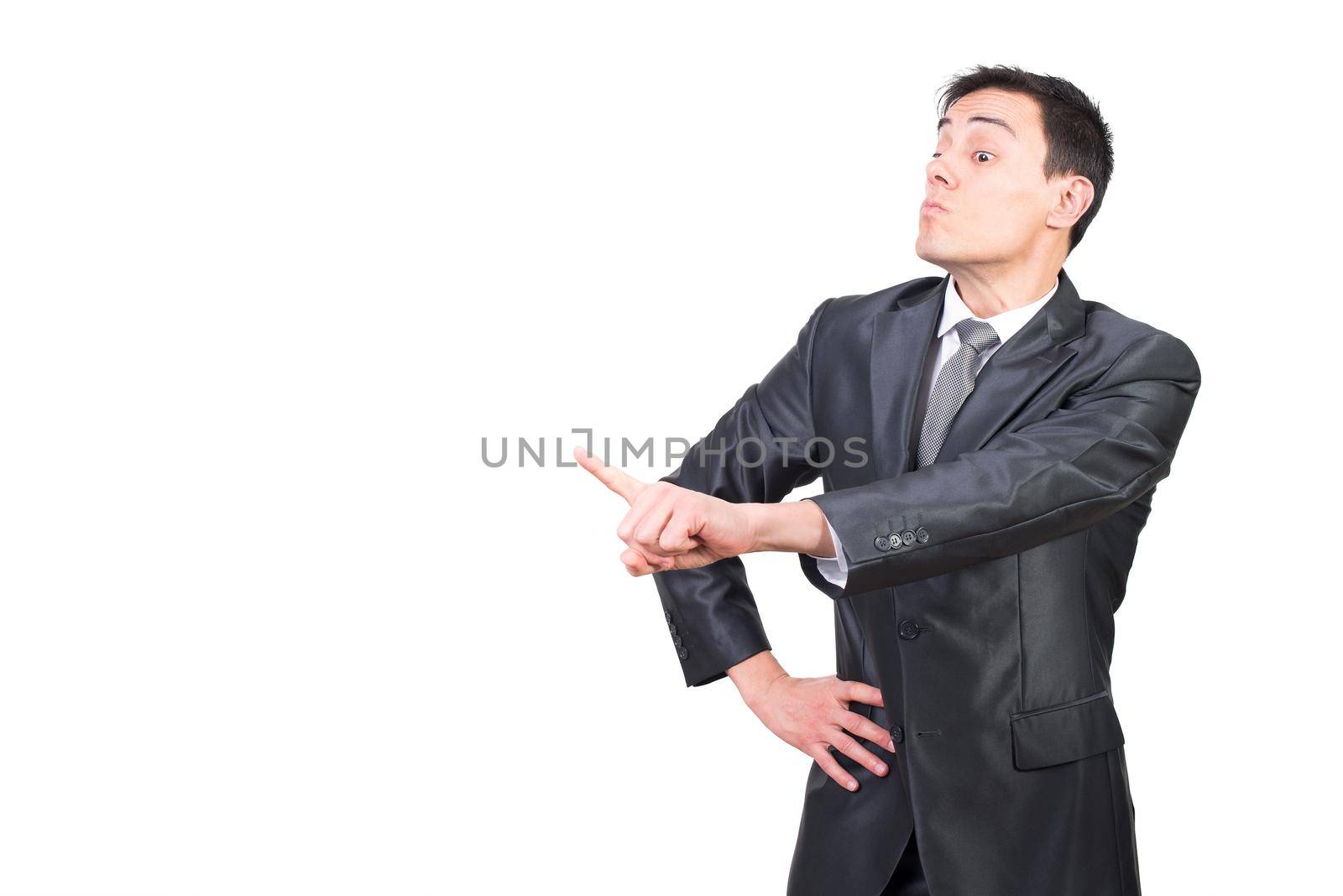 Handsome confident businessman in formal outfit pointing forward and scolding while standing on white background