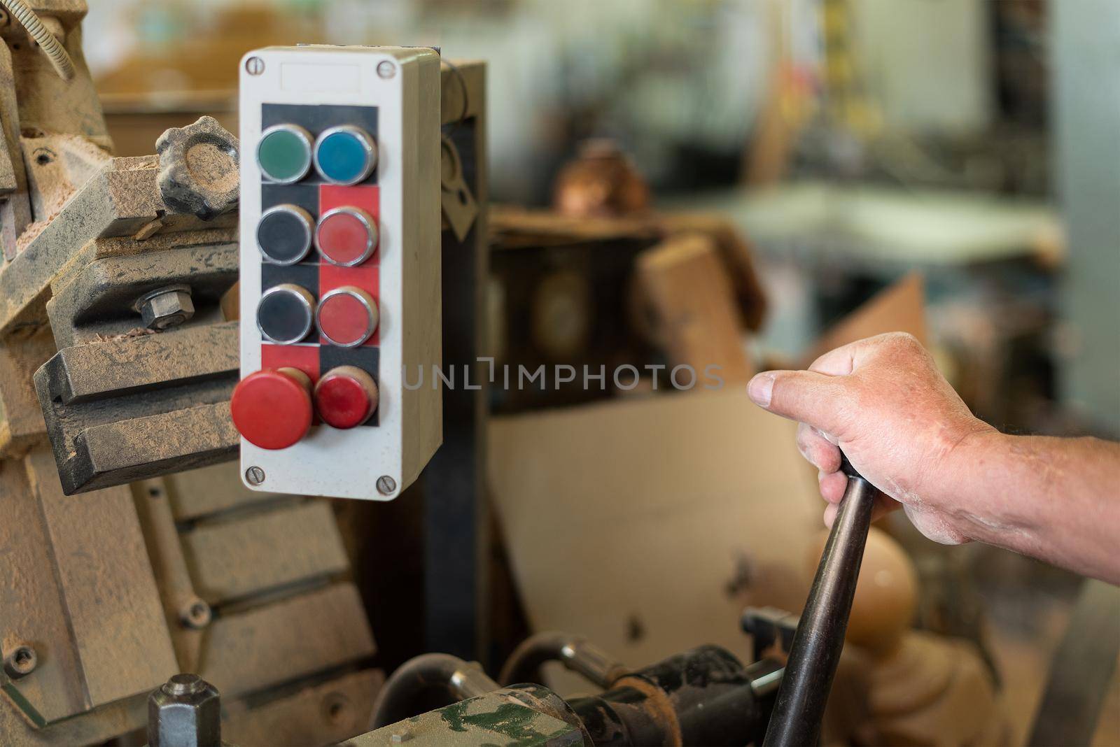 person controlling machinery in a factory, foreground, unfocused background