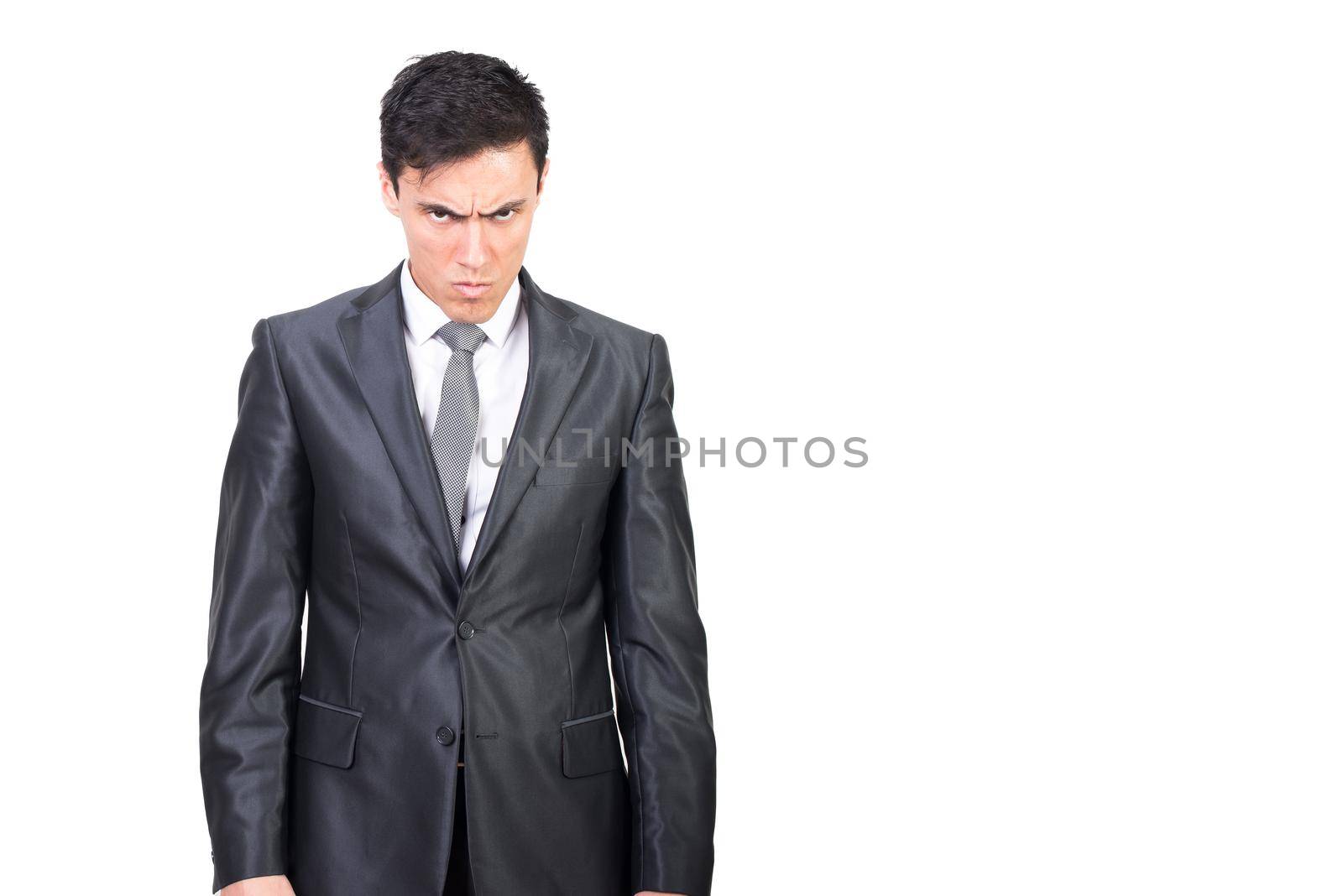 Serious male in classy suit frowning face and gazing at camera with angry negative expression isolated on white background