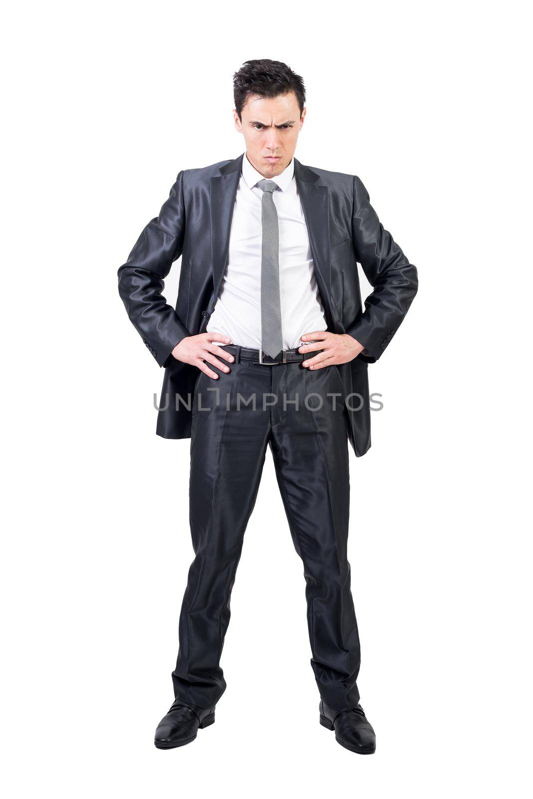 Full body of confident male in formal suit looking at camera with serious face and hands on waist isolated on white background