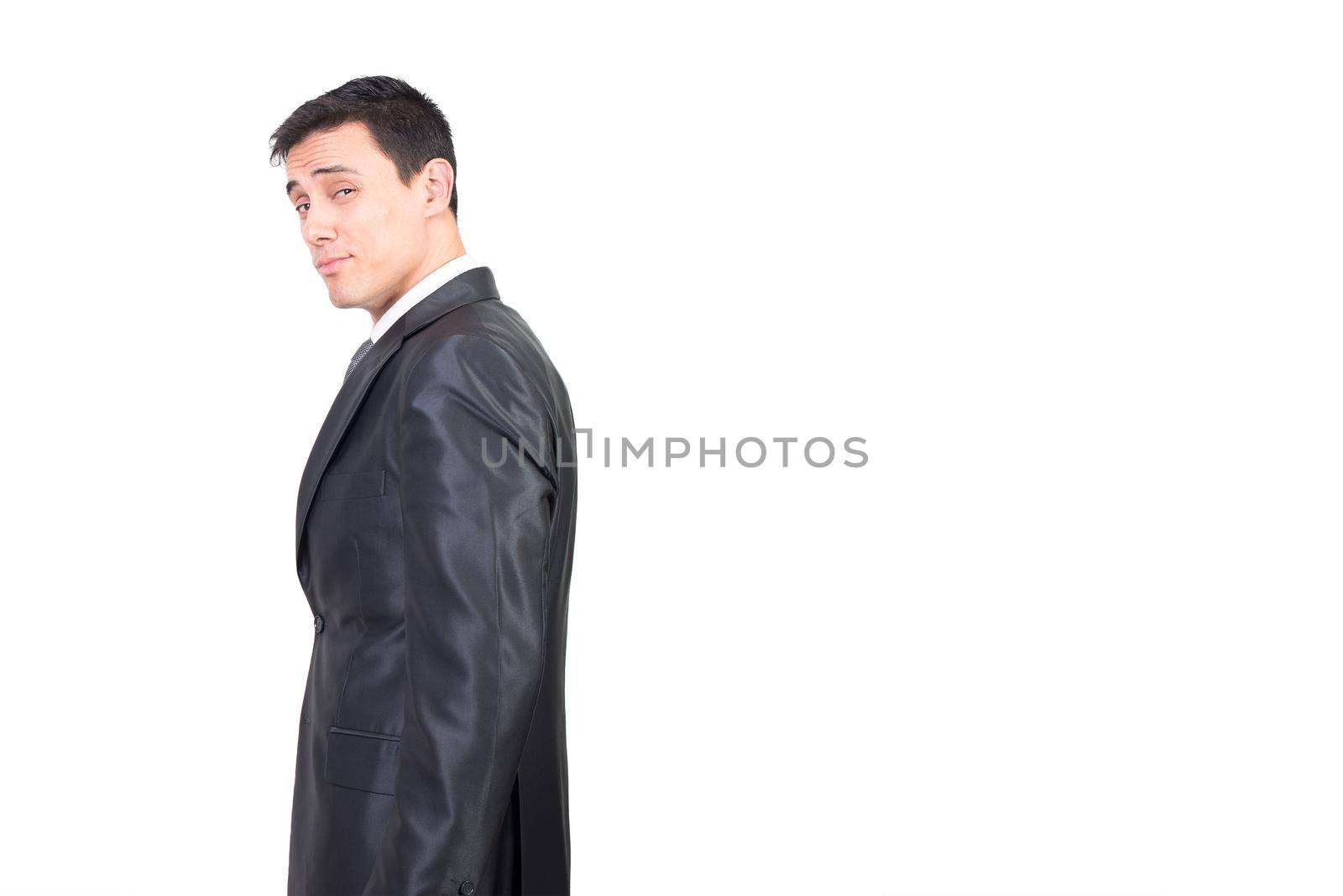 Tempting male in elegant suit looking at camera with alluring face expression while standing isolated on white background in studio