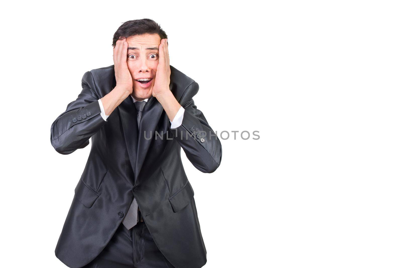 Amazed male entrepreneur in elegant suit touching cheeks and looking at camera with astonished face expression isolated on white background