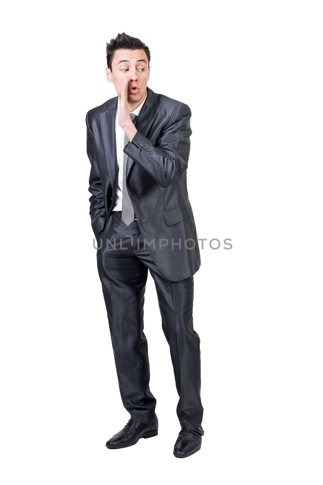 Full length of male entrepreneur in suit spreading rumors on white isolated background in studio