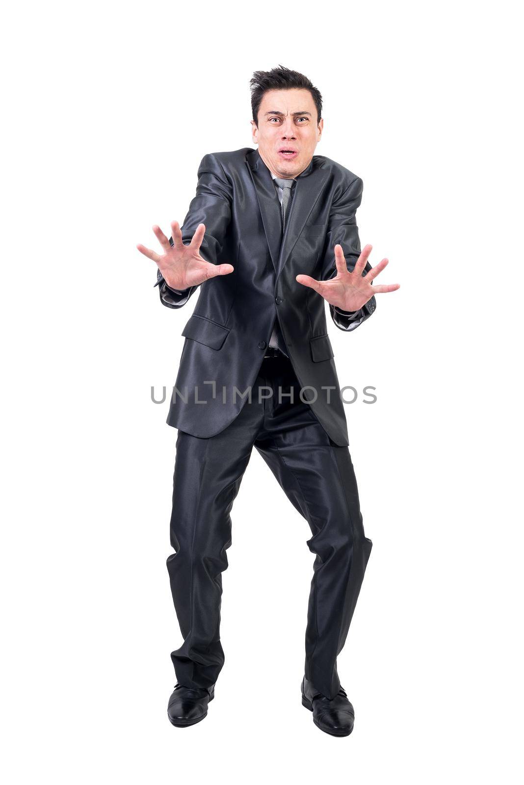 Full body of fearful man in suit showing stop gesture and looking at camera isolated on white background in studio