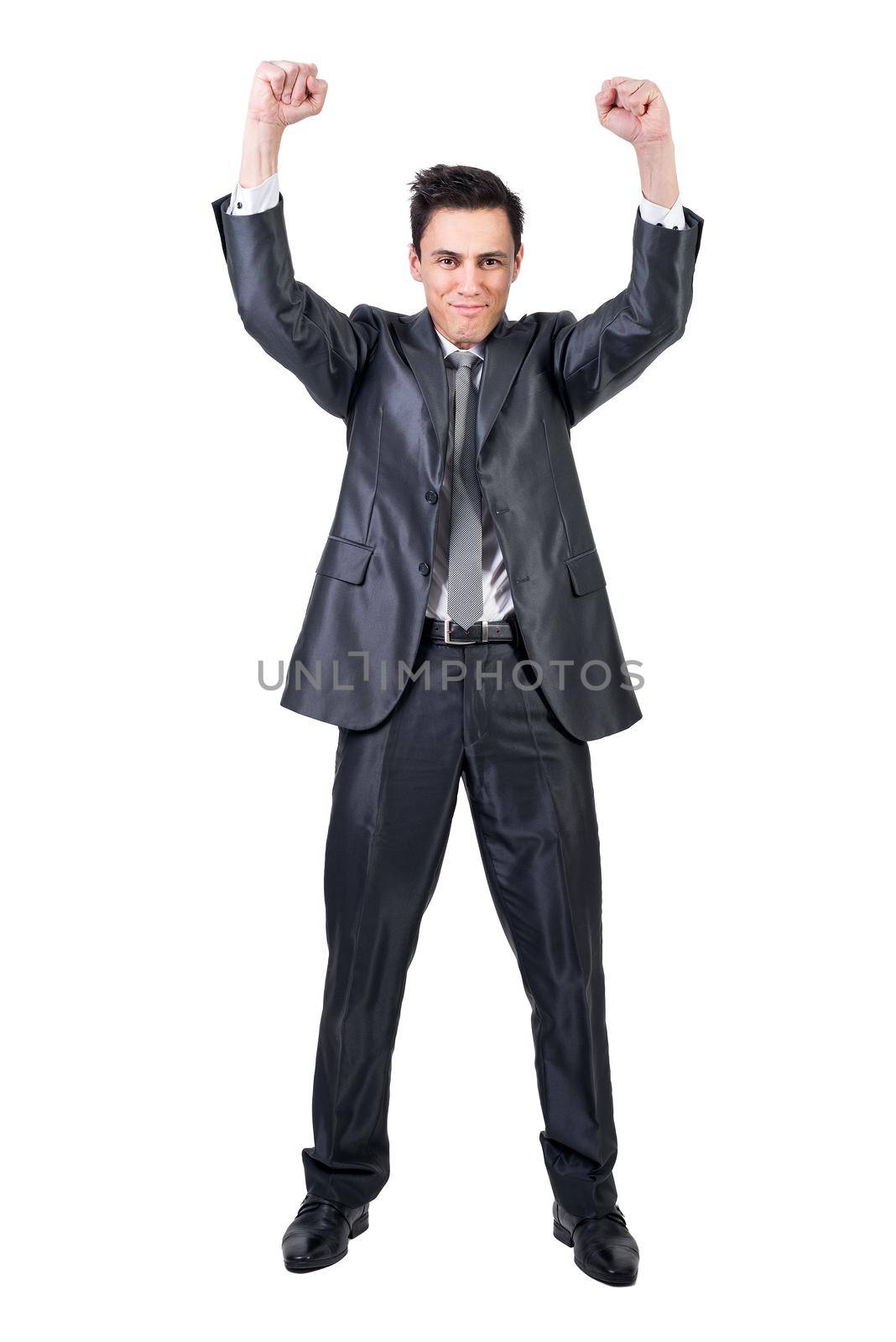 Full body of positive male in formal suit raising clenched fists and looking at camera while celebrating victory isolated on white background in studio