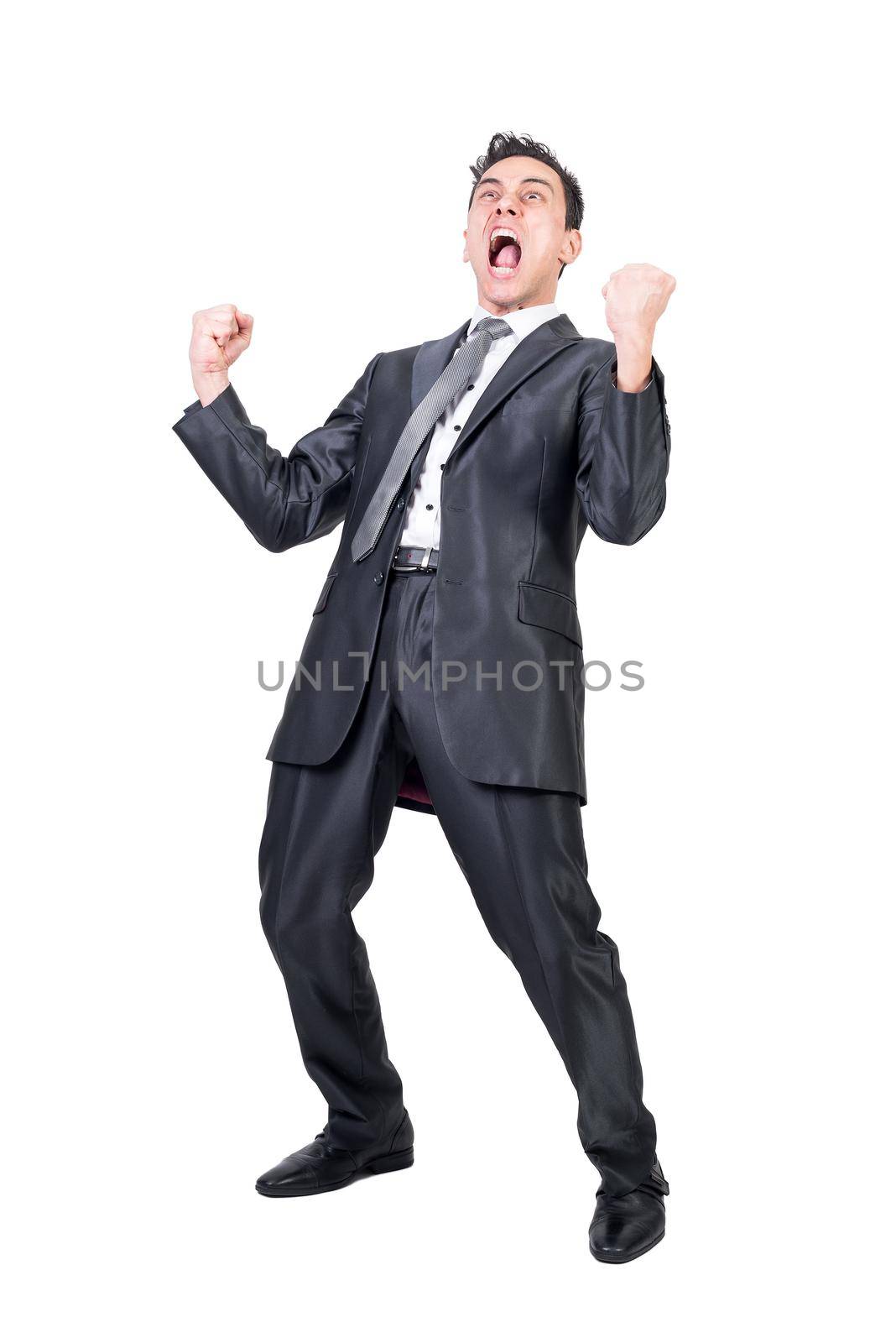 Full length of expressive male entrepreneur in formal suit shouting and celebrating victory with clenched fists on white background