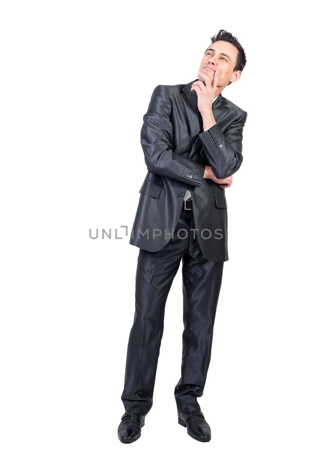 Full length of content pensive male entrepreneur in suit touching chin and looking up on white isolated background