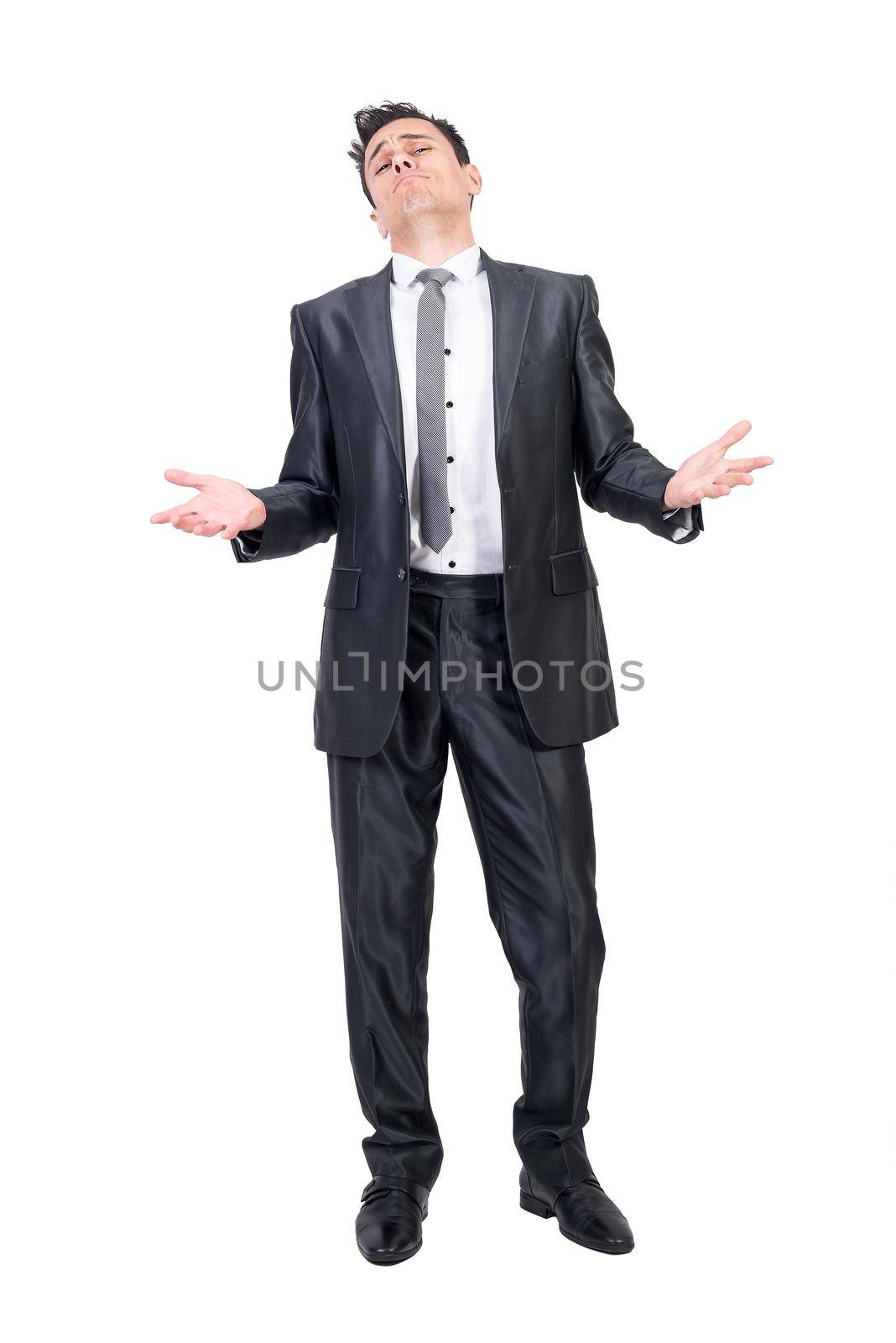 Full body of trusted businessman in elegant suit looking at camera with palms up isolated on white background in light studio