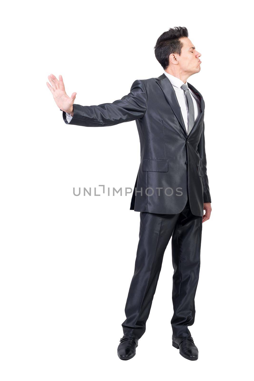 Funny male entrepreneur in suit showing stop gesture and expressing anger on white isolated background