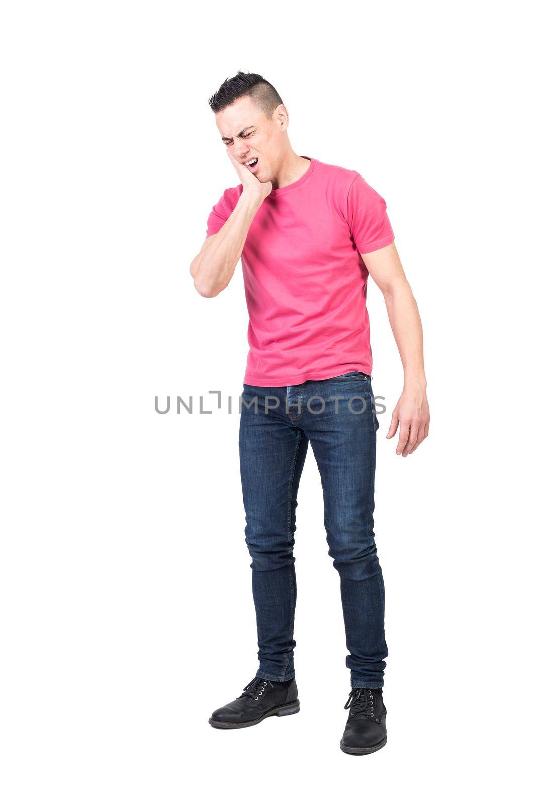 Man in casual clothes touching cheek and closing eyes while suffering from toothache against white background