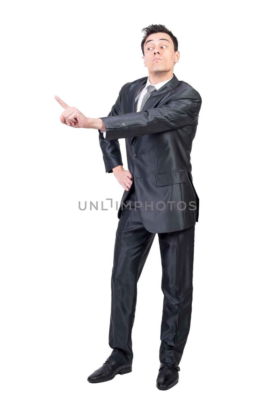 Full body of expressive male entrepreneur in formal suit showing no gesture while standing with hand on waist and blaming for mistakes in studio against white background