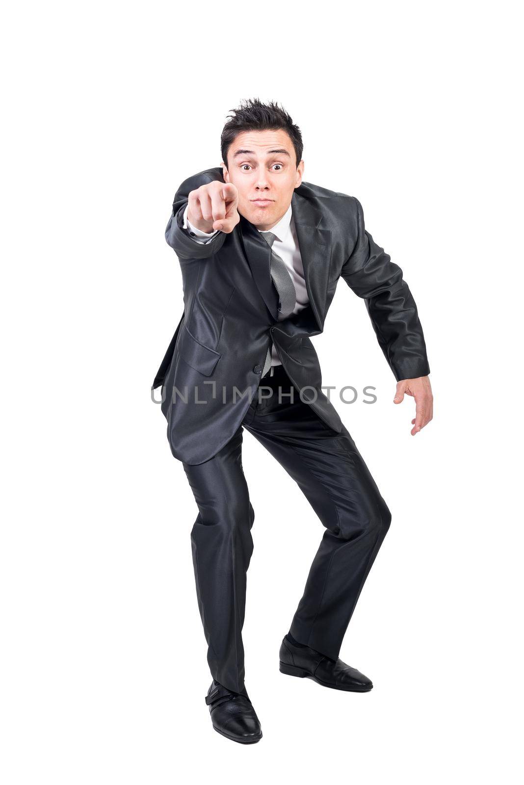 Full body of male in formal suit pointing and looking at camera isolated on white background in light studio