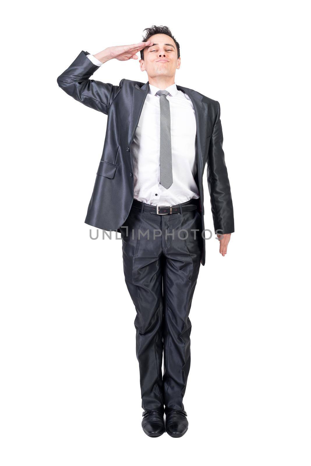 Full body of glad male soldier in formal suit saluting with closed eyes isolated on white background in light studio