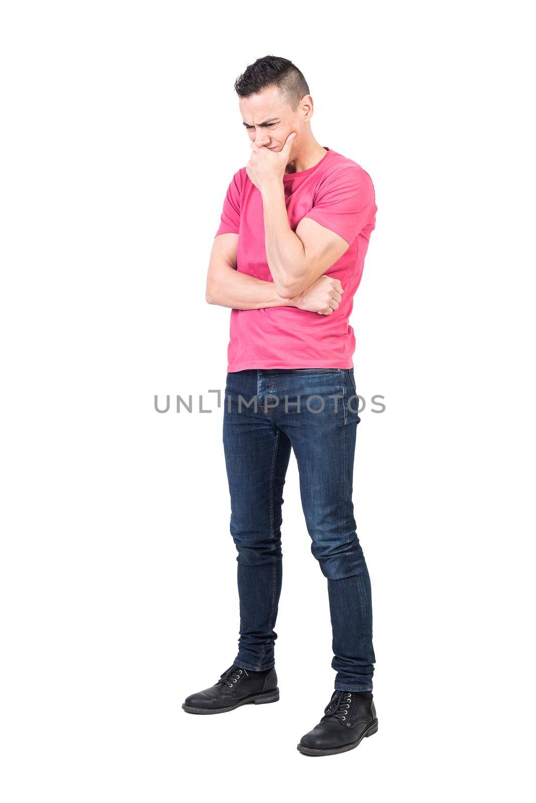 Full body of concern male model covering mouth and thinking on question on white background