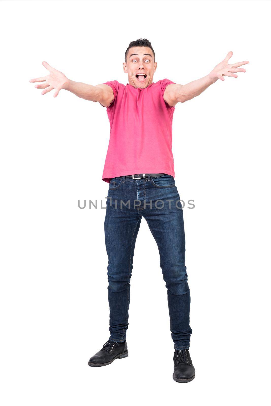 Full body happy male in jeans and pink t shirt stretching out arms and trying to embrace camera isolated on white background