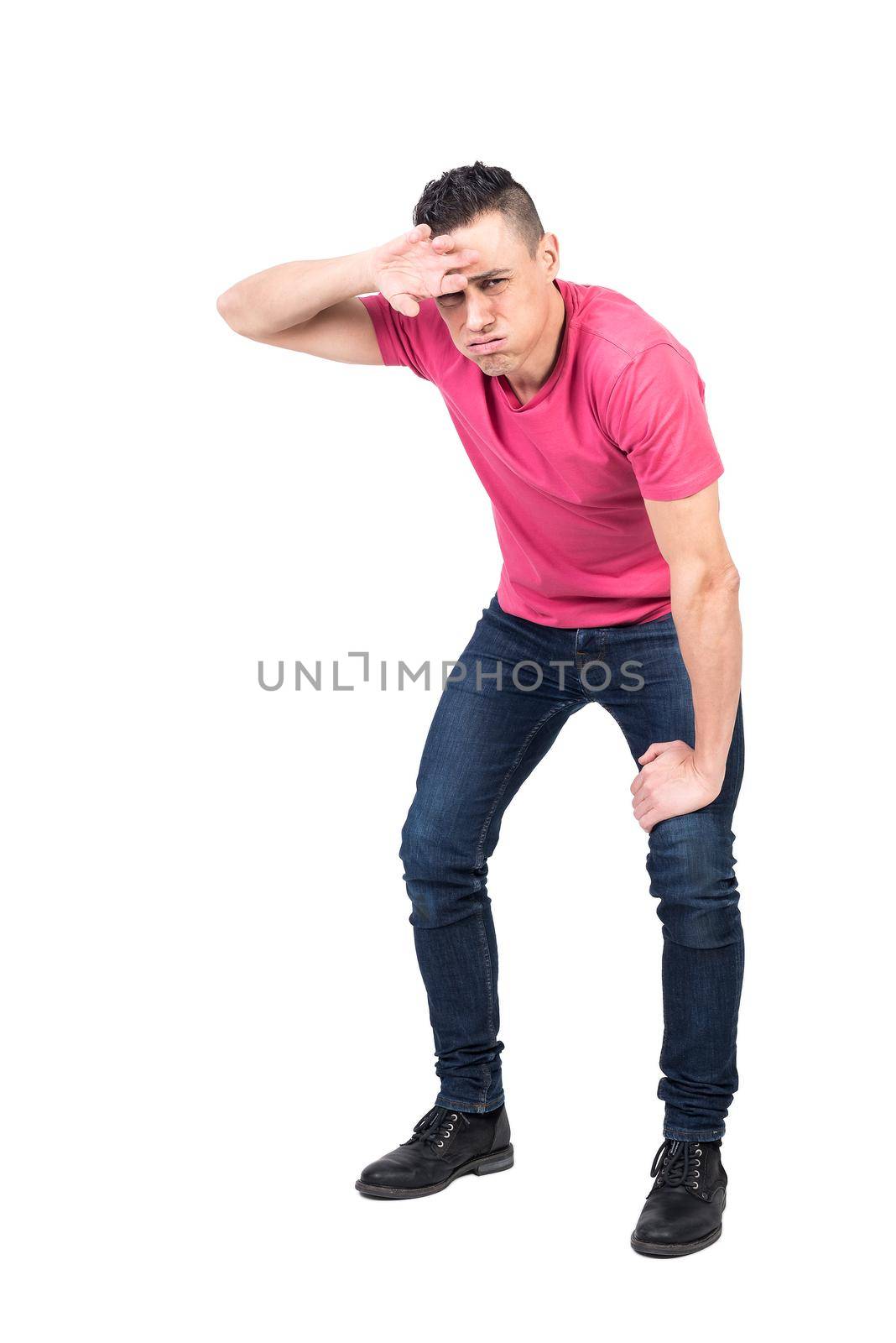 Full length weary man panting and wiping sweat from forehead while leaning on knee an looking at camera against white background