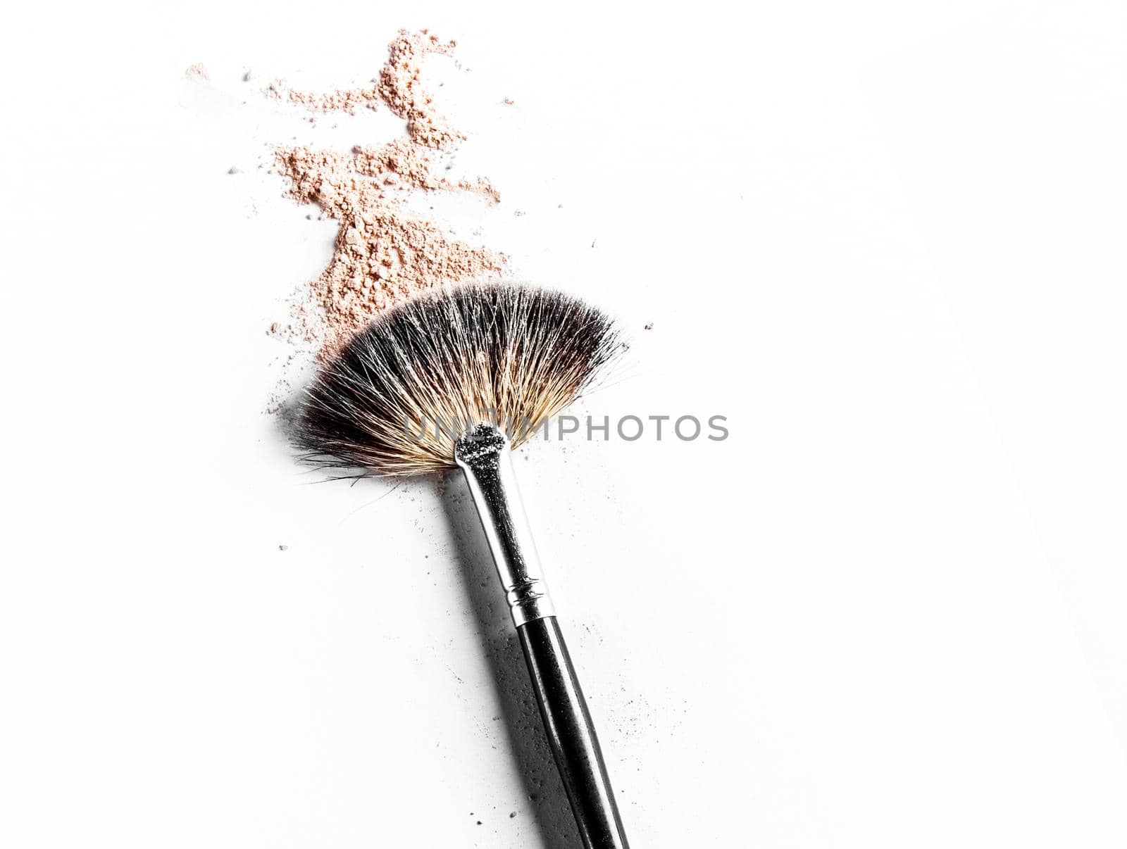 Beauty texture, cosmetic product and art of make-up concept - Brush and beige powder close-up isolated on white background