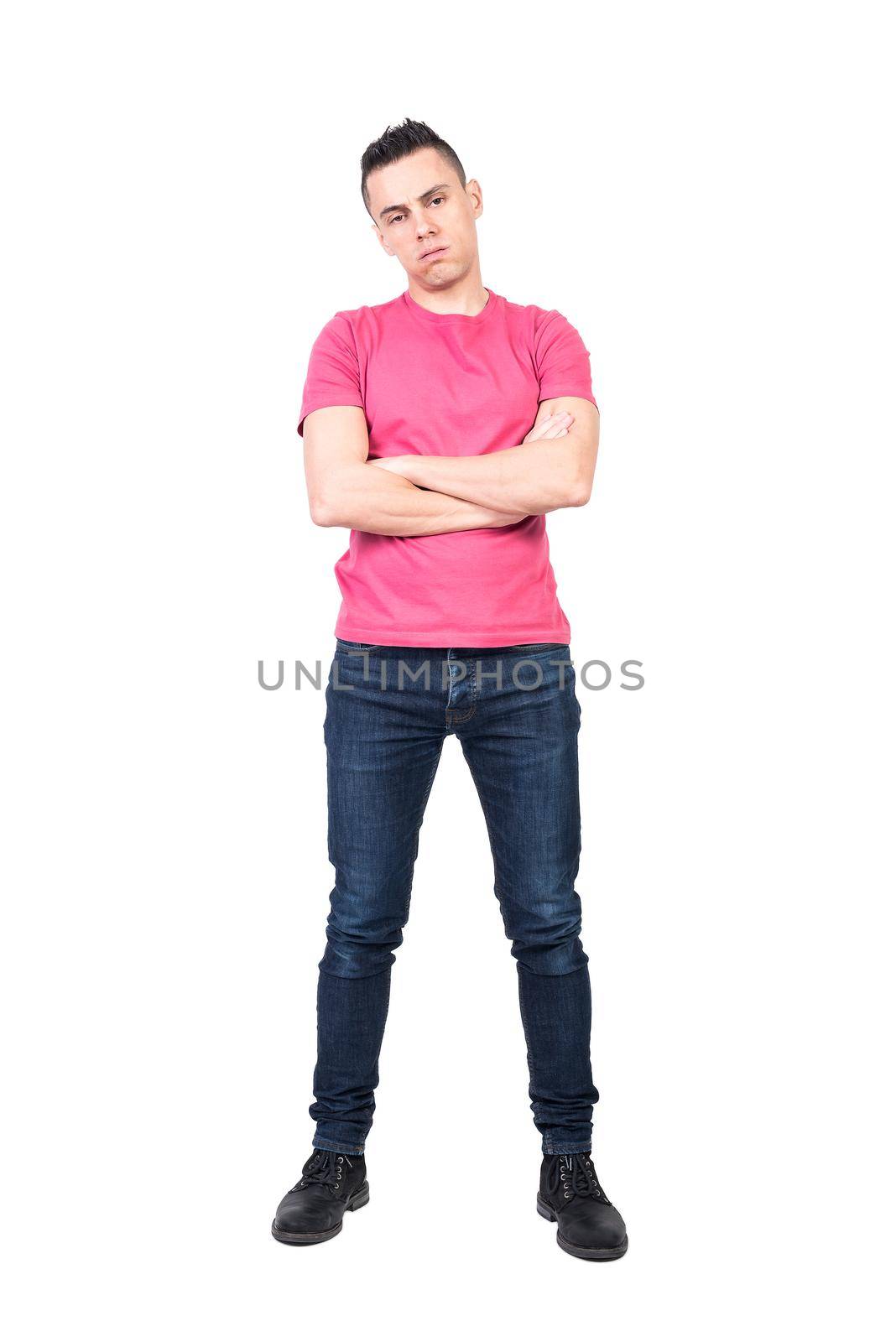 Full body weary man in pink t shirt and jeans crossing arms and looking at camera isolated on white background